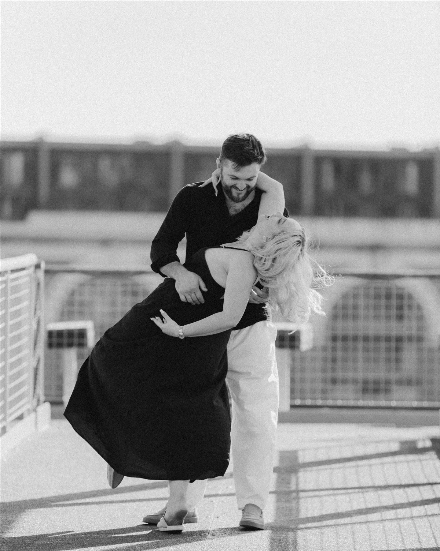 He dips her in a dance on the footbridge