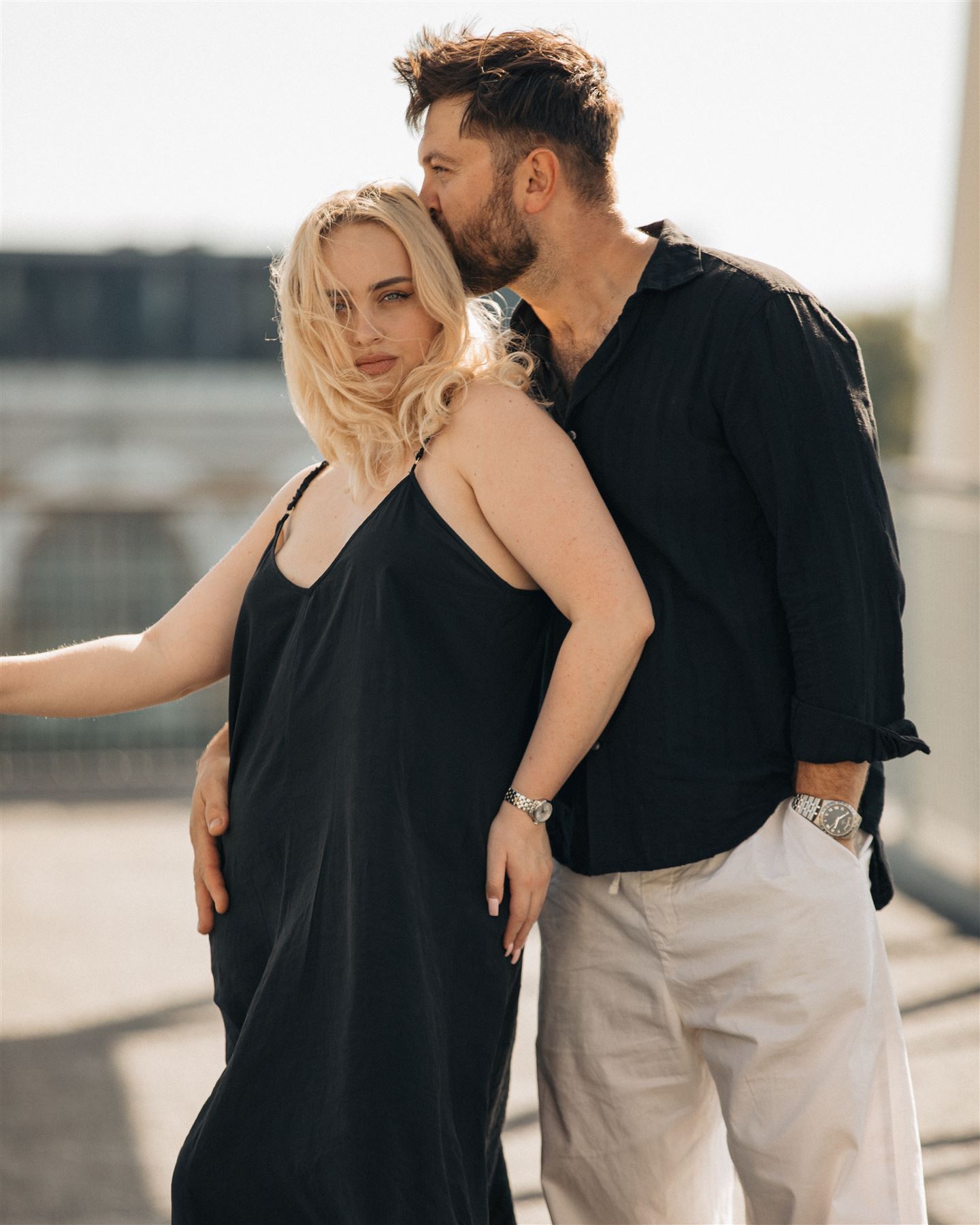 He kisses her temple, she smiles