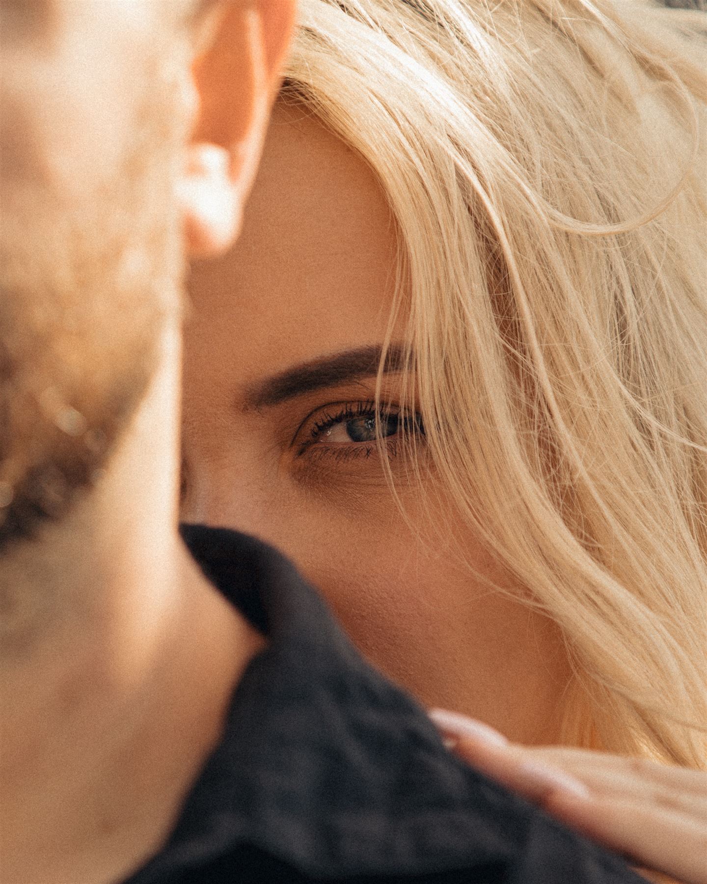 Close-up of her eyes over his shoulder