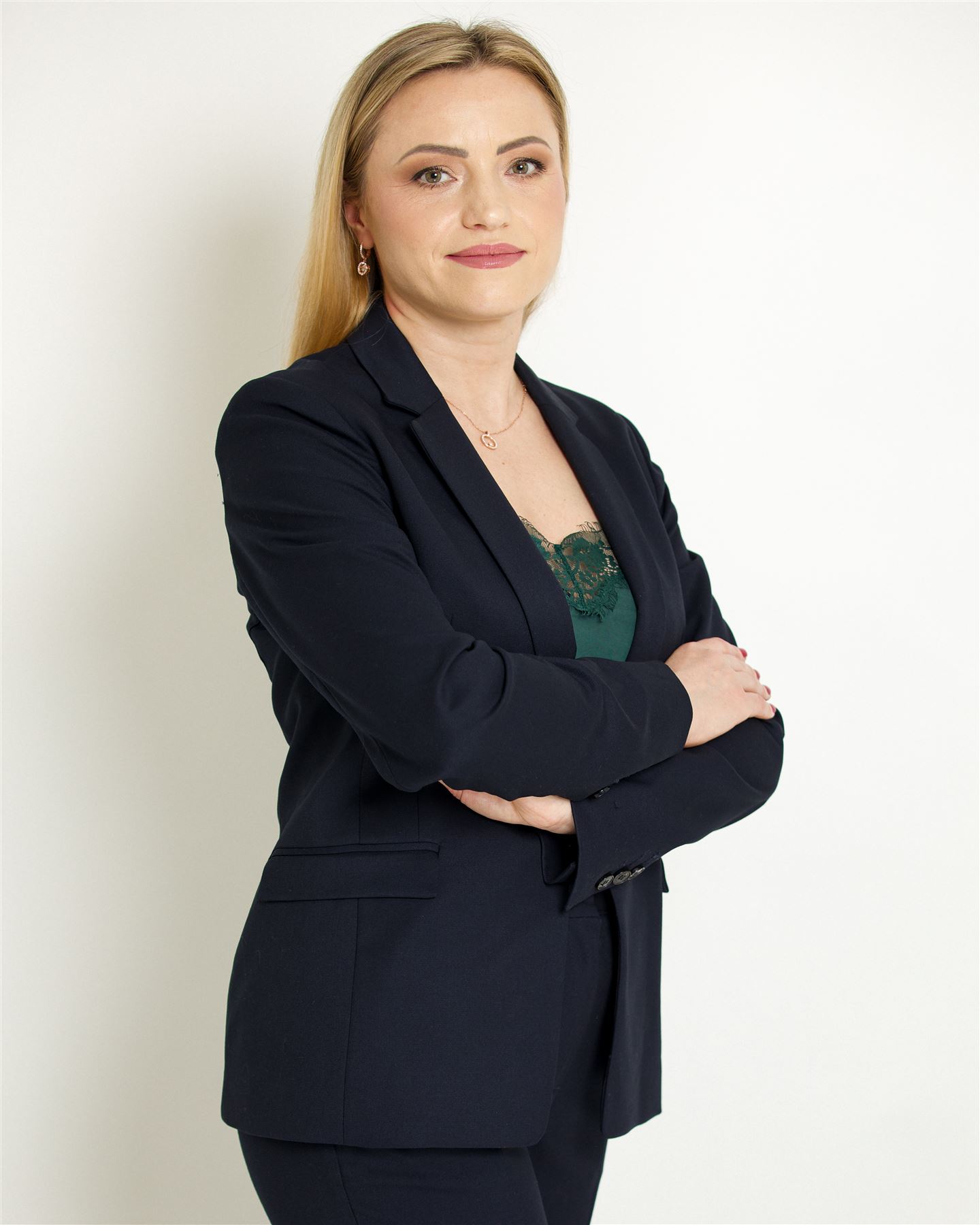 Aliona in a navy suit, arms crossed
